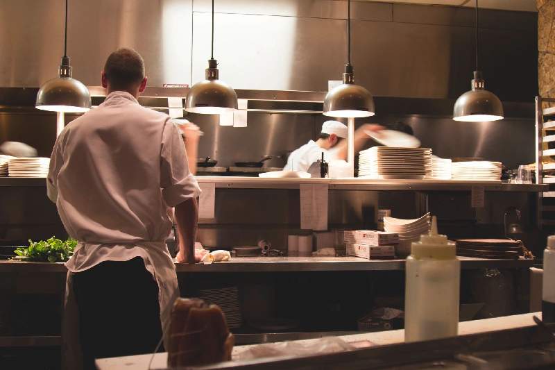 A man standing in front of a kitchen counter.